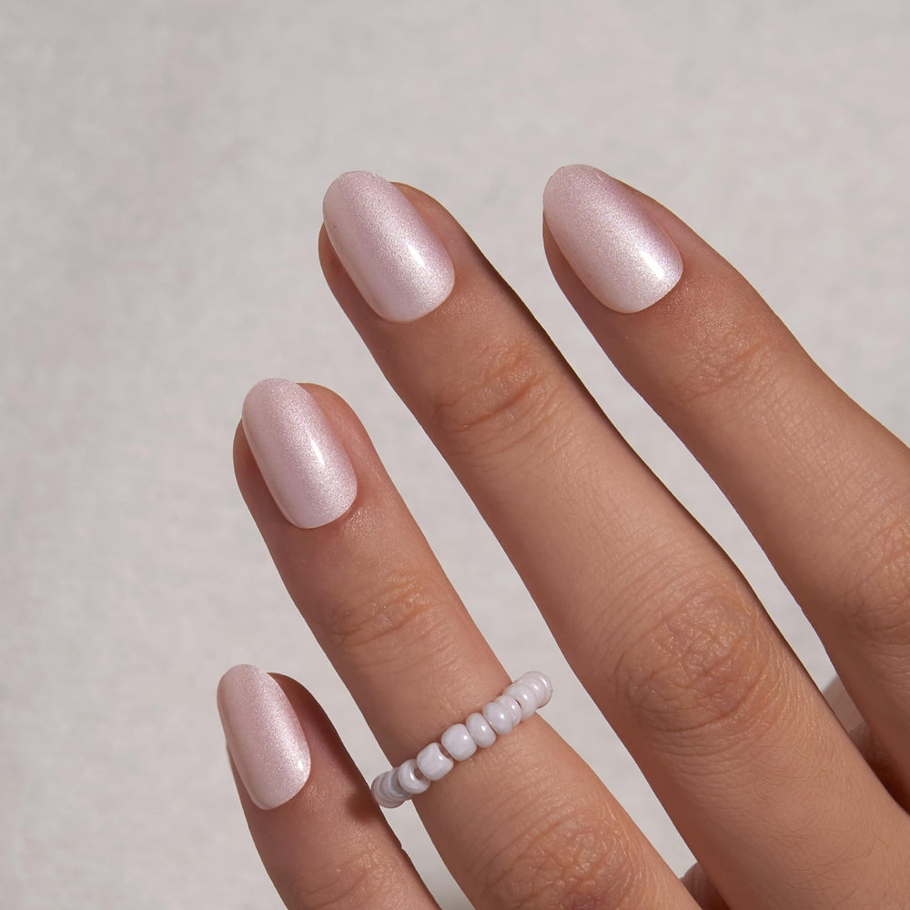 Curvlife short oval Moonlight Pearly Shimmer nails secured with glue for durable wear.