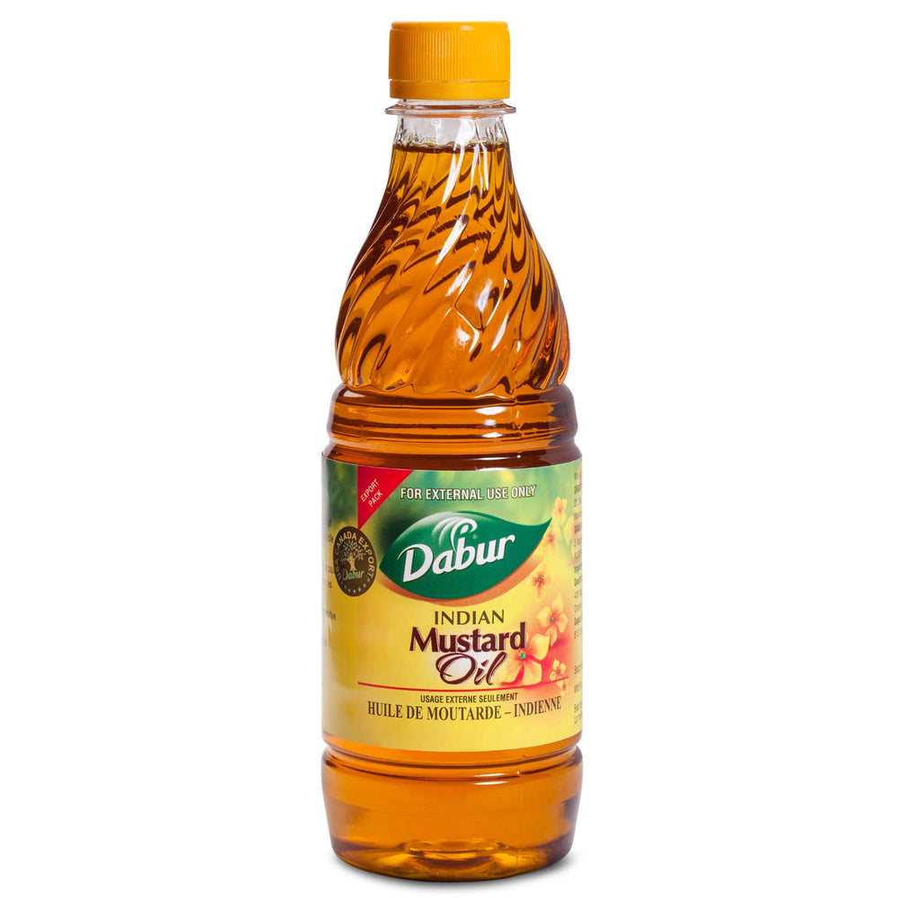 Dabur Kachi Ghani Mustard Oil bottle being poured for skin and hair care.