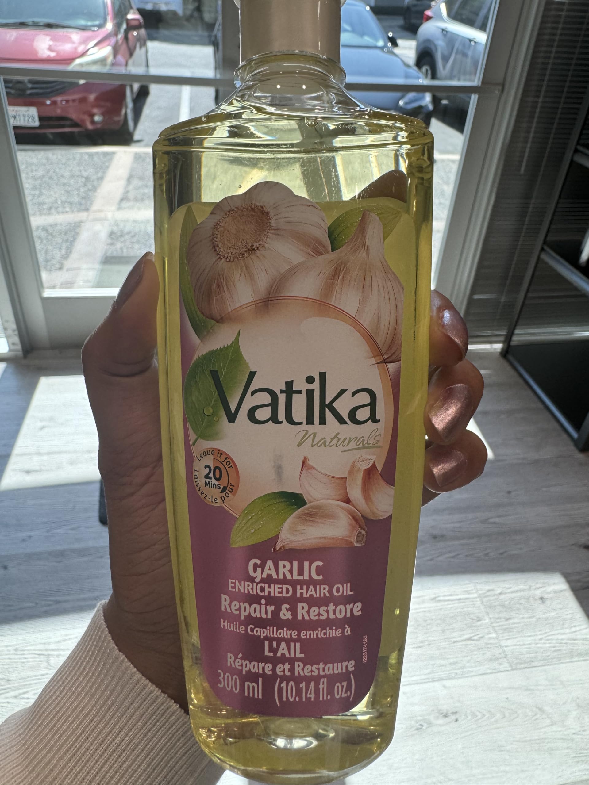 Close-up of garlic essence in Dabur Vatika Enriched Hair Oil for nourishing care.