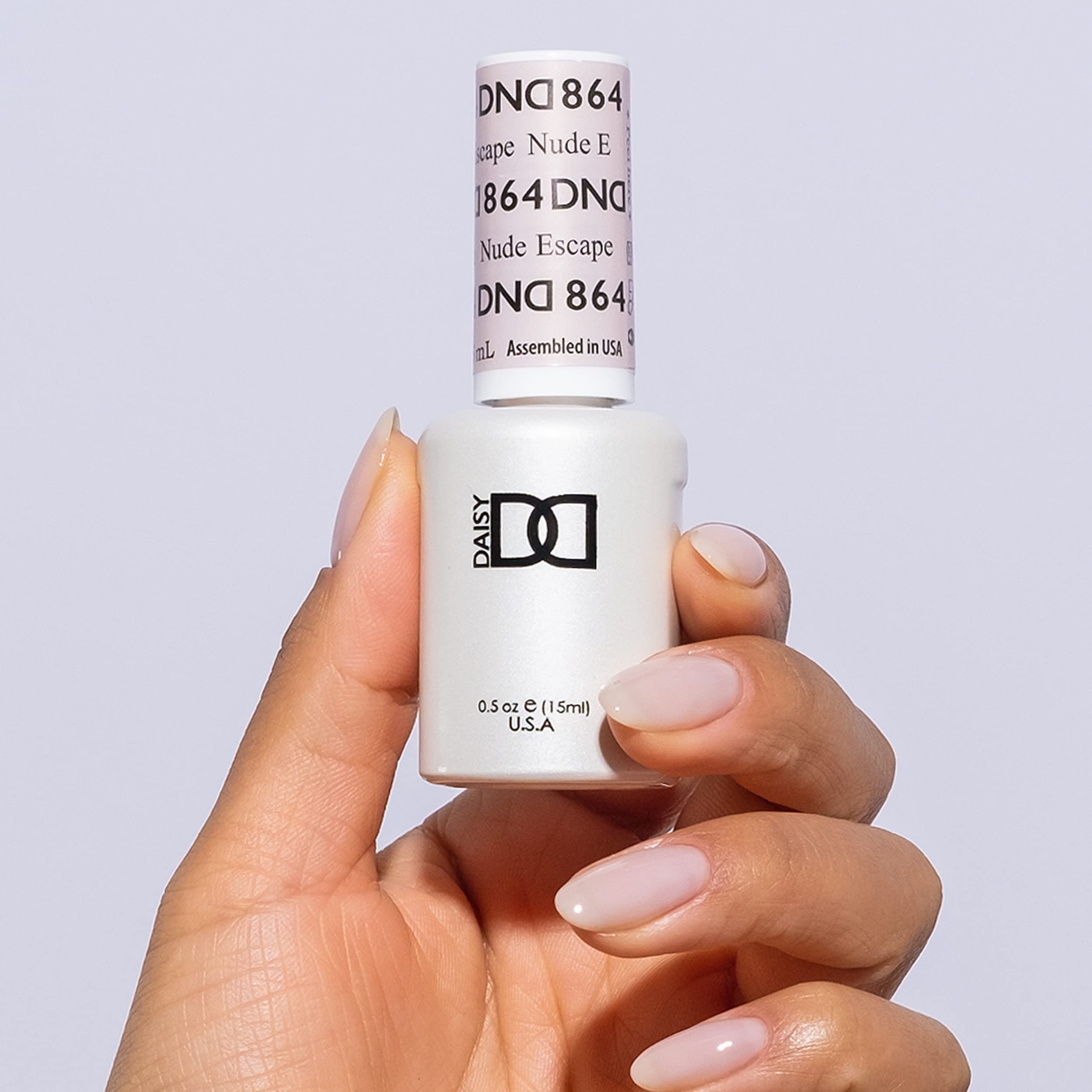 Daisy DND Nude Escape lacquer bottle paired with gel polish for long-lasting manicure.