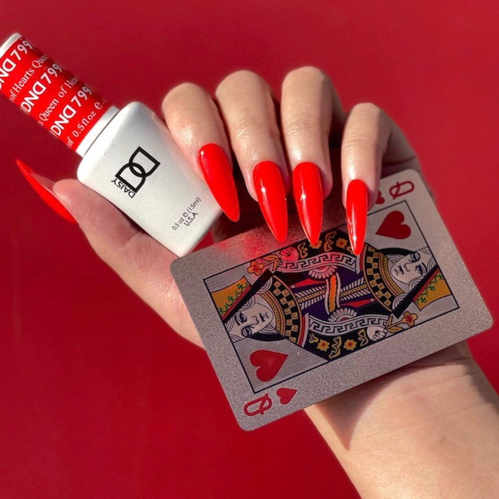 Daisy DND Queen of Hearts nail lacquer bottle paired with gel polish for a coordinated red manicure.