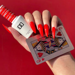 Daisy DND Queen of Hearts nail lacquer bottle paired with gel polish for a coordinated red manicure.