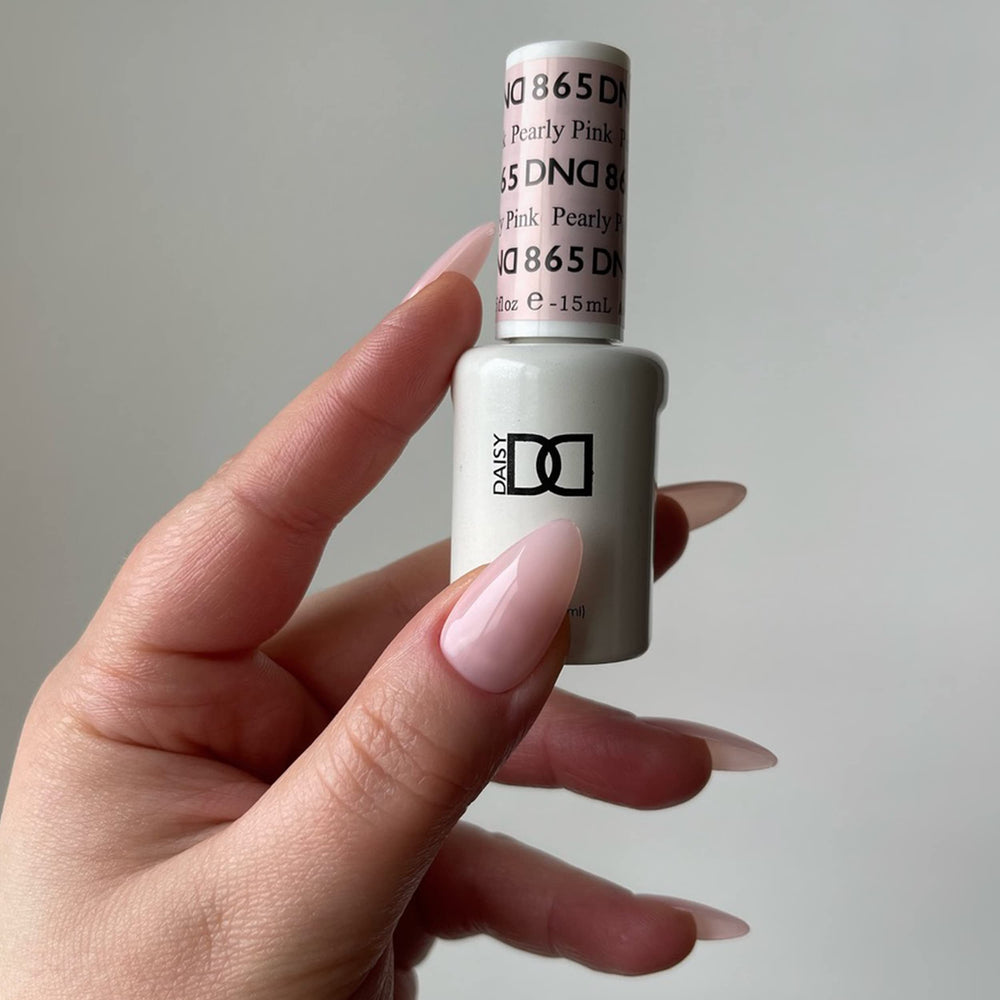 Daisy DND soak-off-ready polish near warm water to ease removal.