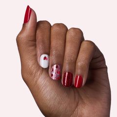 Dashing Diva Valentine nails close-up showing glitter hearts for festive style.