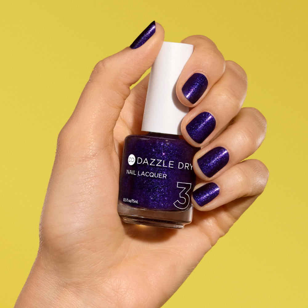 Dazzle Dry nail lacquer applied on nail for smooth coverage.