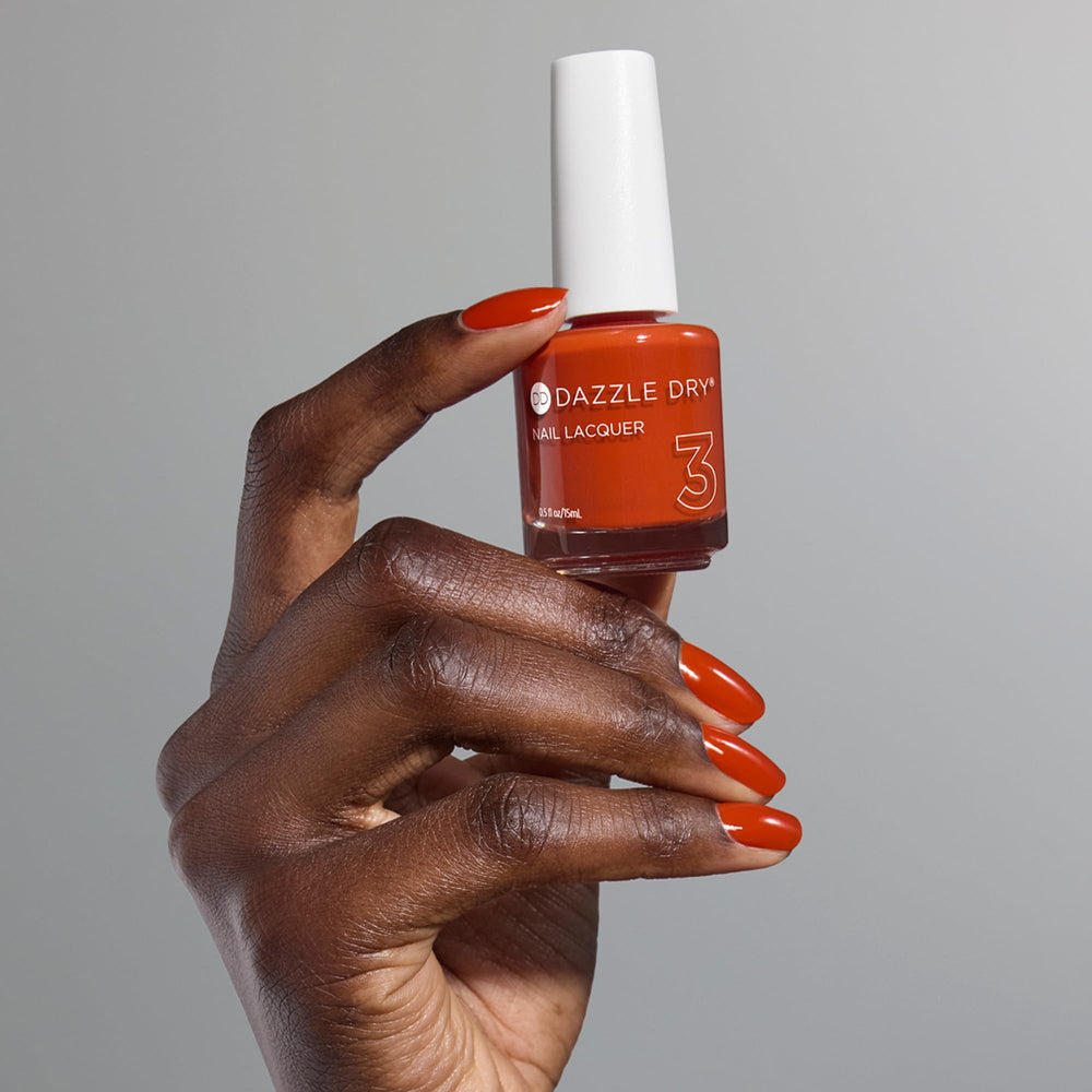 Dazzle Dry nails in Orchard orange for a polished manicure.