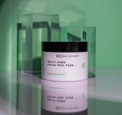 Applying a DCL G10 Radiance Peel pad to skin for brightening exfoliation.