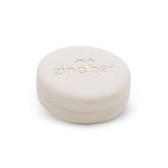 DermaHarmony pyrithione zinc bar close-up with visible lather for gentle cleansing.