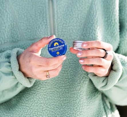 Applying Dermatone balm to lips outdoors for windburn and sun defense.