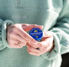 Dermatone balm tin in holiday gift pack highlighting SPF23 sun and wind protection.