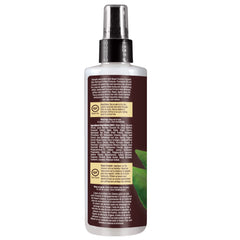 Desert Essence coconut defrizzer being applied to hair for a smooth finish.