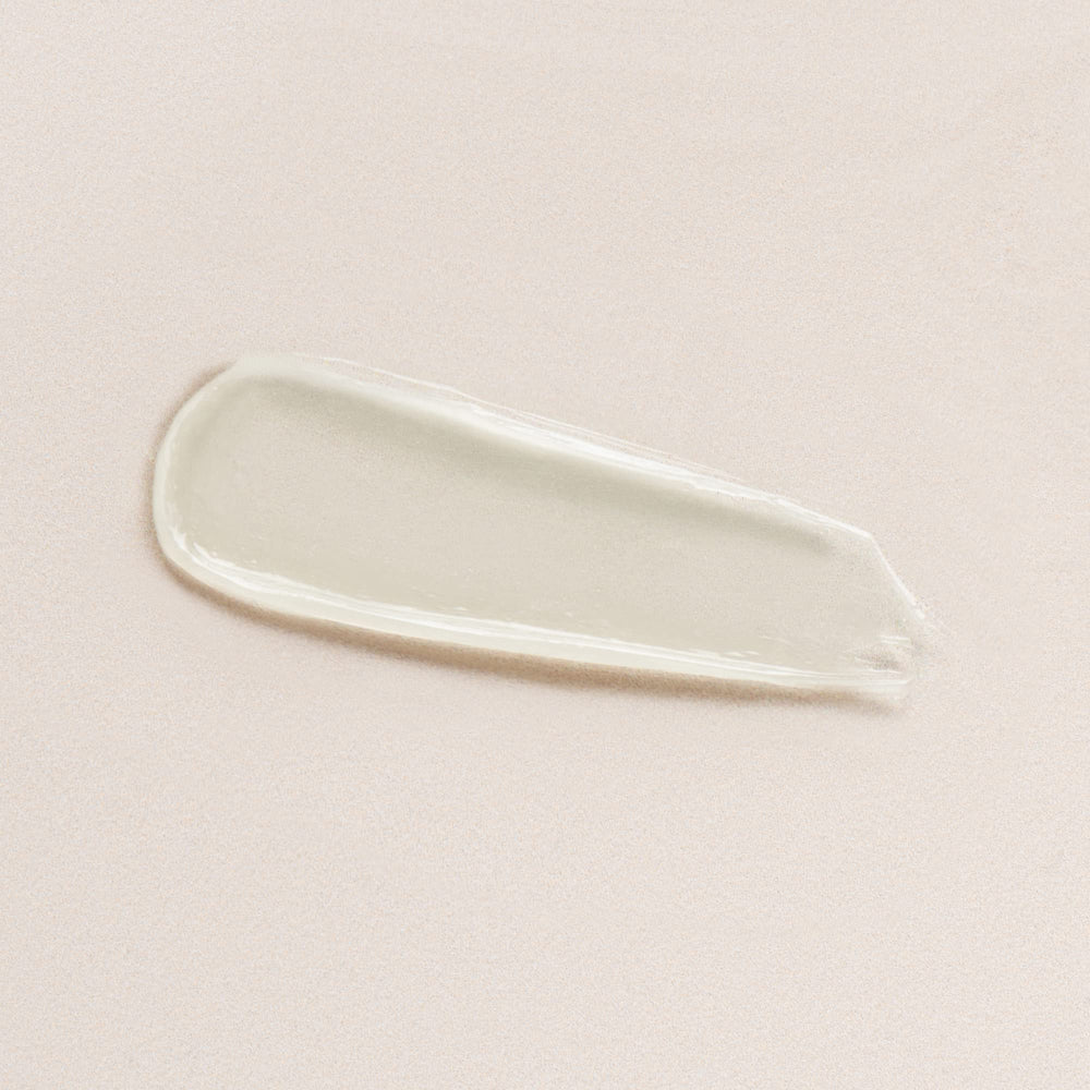 Close-up of DIME Lip Balm jar reveals creamy, nourishing texture.
