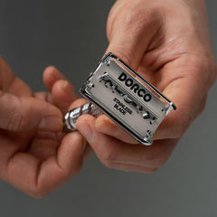 Dorco ST301 blades held in hand for a controlled, close shave.