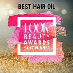 Dove Keratin Smooth Shine Oil being applied to towel-dried hair for detangling