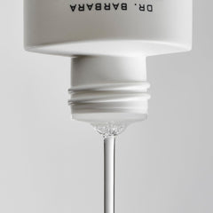 Applying Dr. Barbara Sturm Balancing Toner to reduce pore appearance