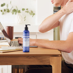 Dr Bronner's Peppermint lotion being massaged into hands for cooling relief.