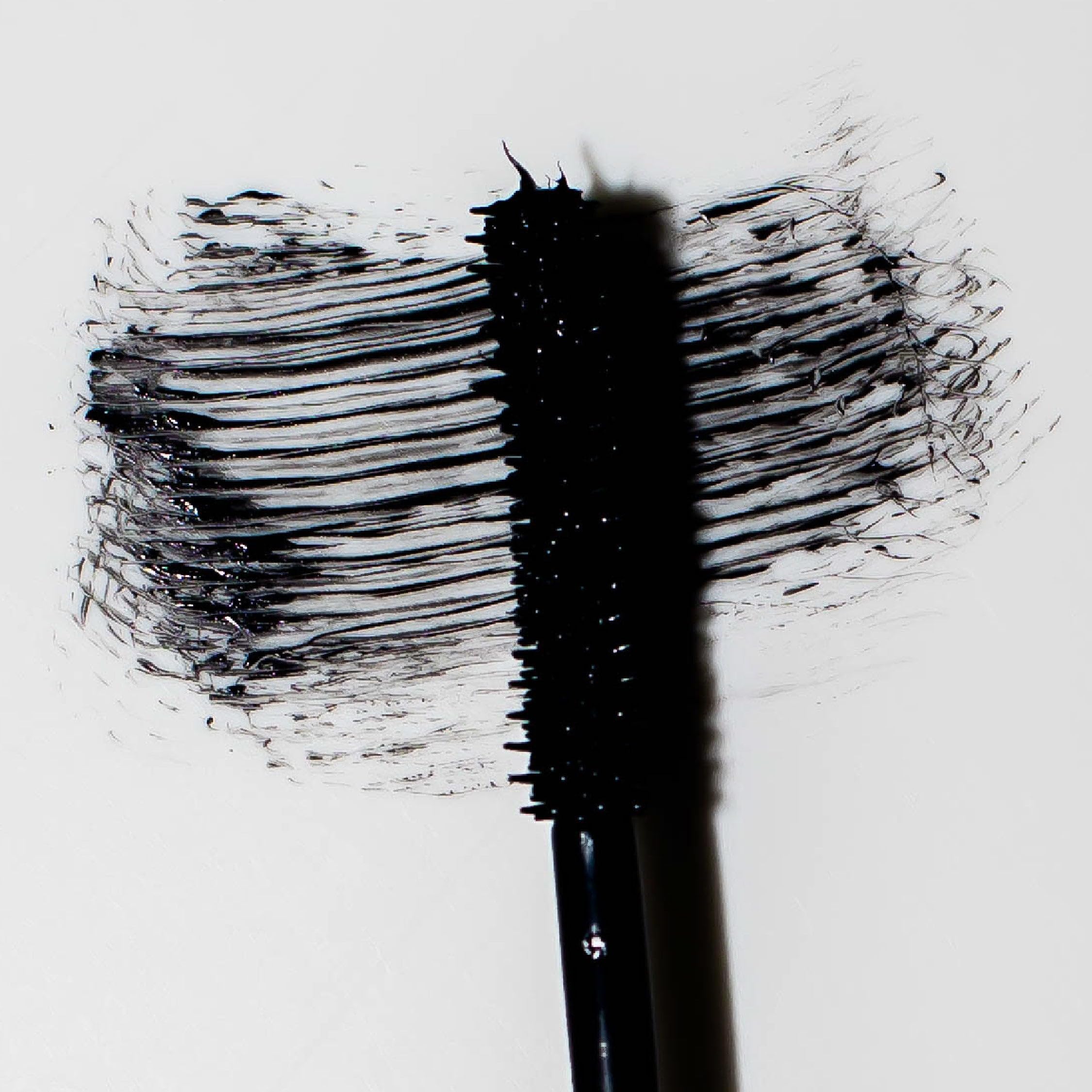 Lashes before application appear shorter with minimal curl.