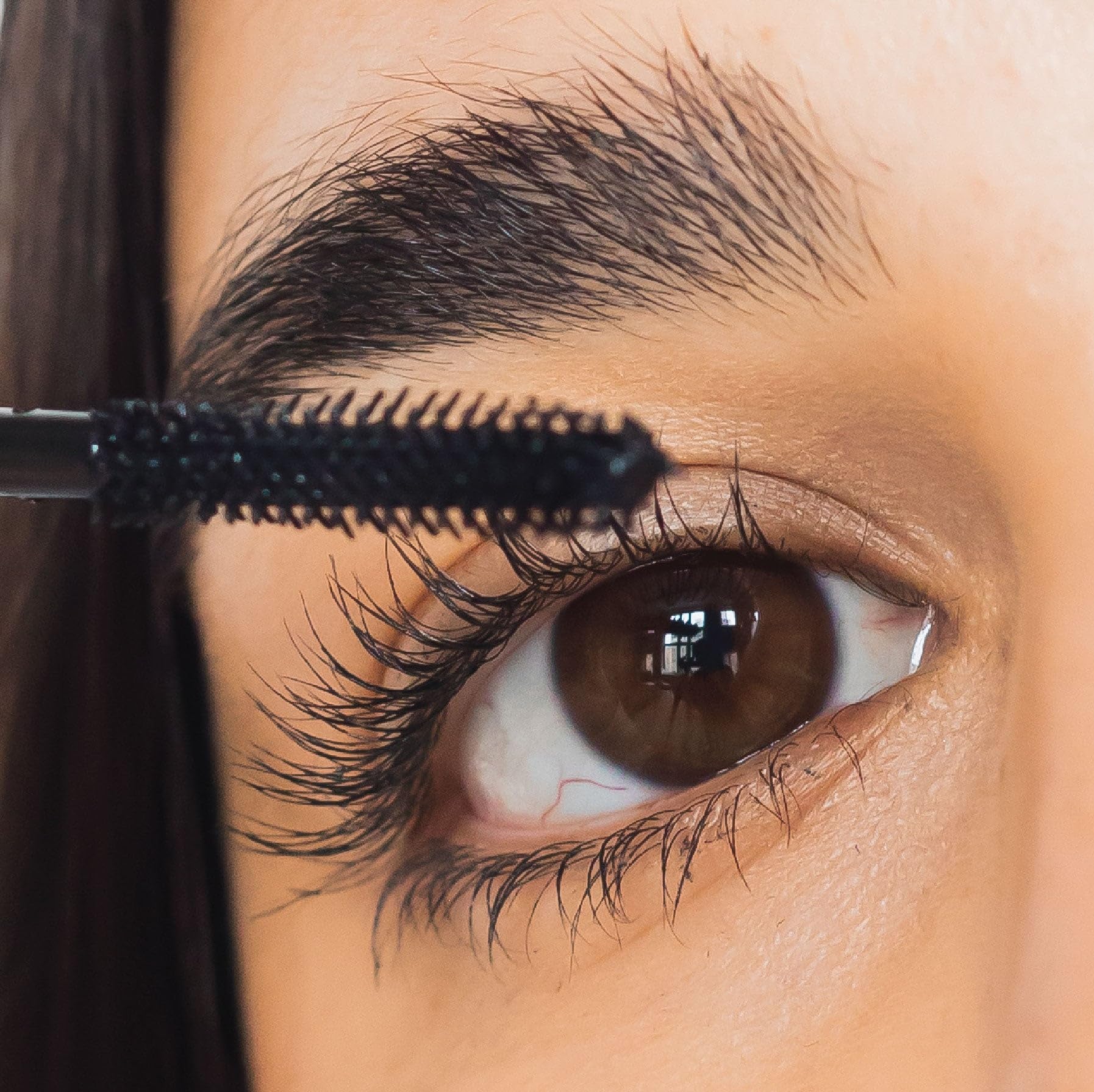 Swatch shows deep pigment and smooth mascara texture.
