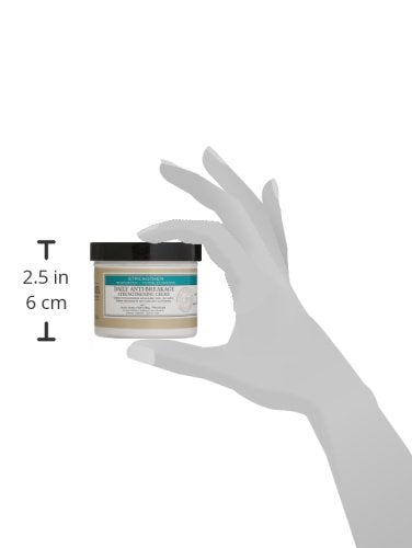 Dr. Miracle's Strengthen Daily Creme on hair ends for smoother detangle and potential breakage support.