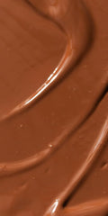 Close-up of mineral pigments delivering sunlit warmth across the complexion.