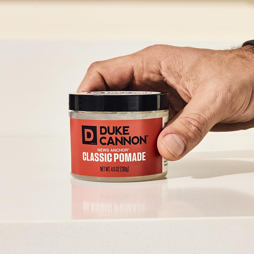Hands applying Duke Cannon pomade demonstrates even distribution