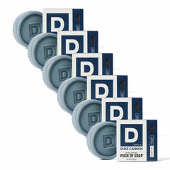 Duke Cannon Midnight Swim bar soap puck in hand for a refreshing six-pack cleanse.