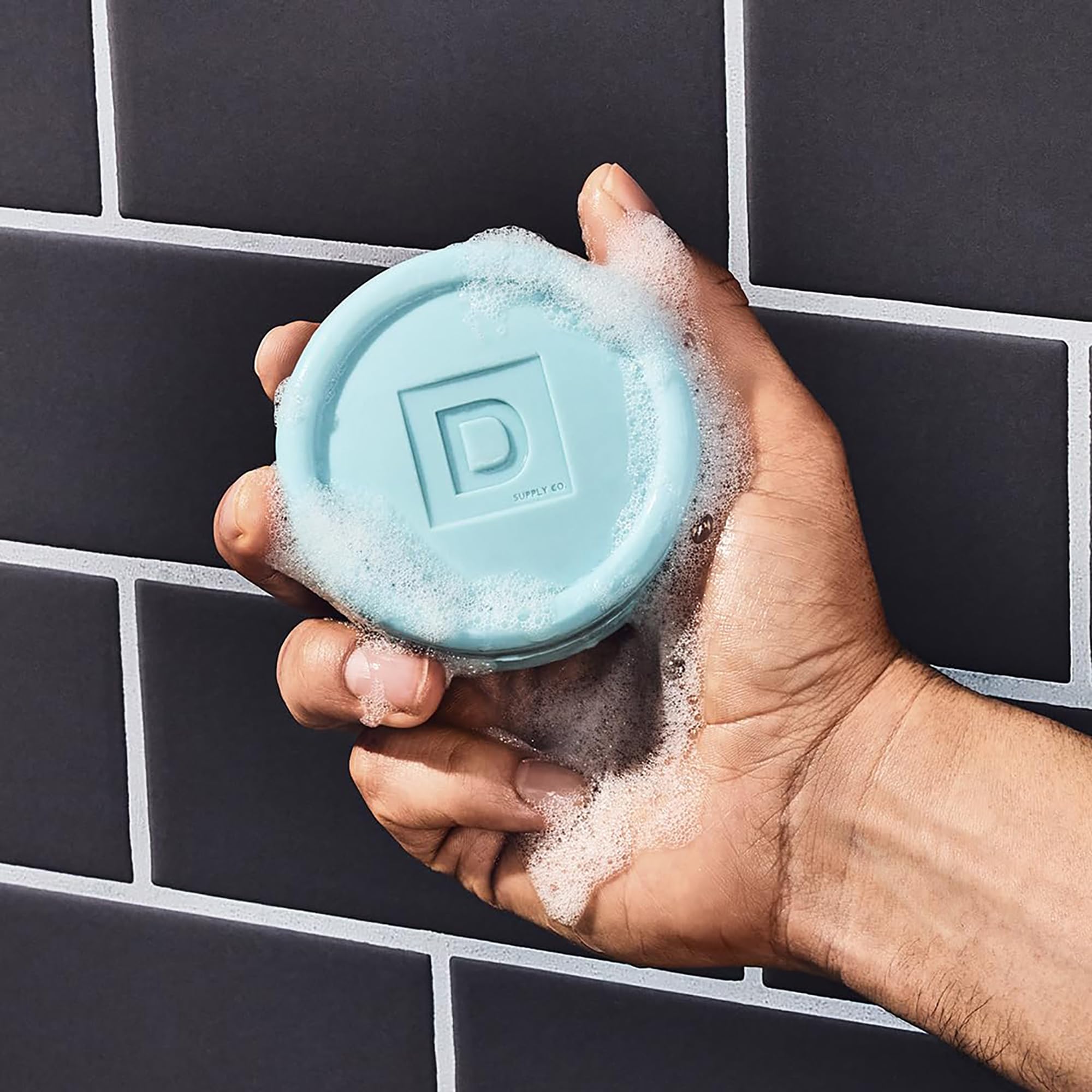 Duke Cannon puck soap close-up texture showing triple-milled durability.