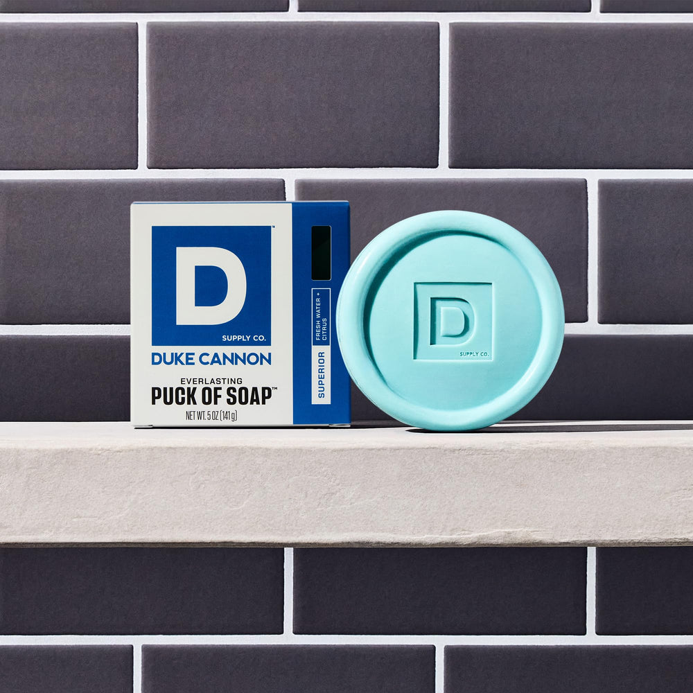 Duke Cannon puck soap in shower highlighting hydrating cleansing action.