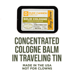 Duke Cannon Bay Rum solid cologne tin closeup shows compact travel-friendly design.