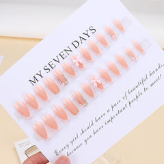 DZPGUONIZ bow accent nails with rhinestones for chic party-ready style.