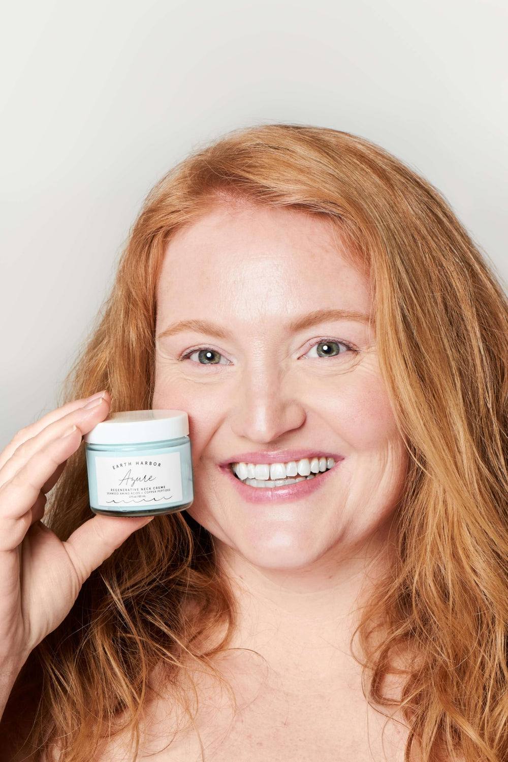 Earth Harbor AZURE application scene—creamy texture gliding smoothly on neck