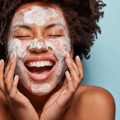 Creamy foam texture shown by the cleanser on skin surface.