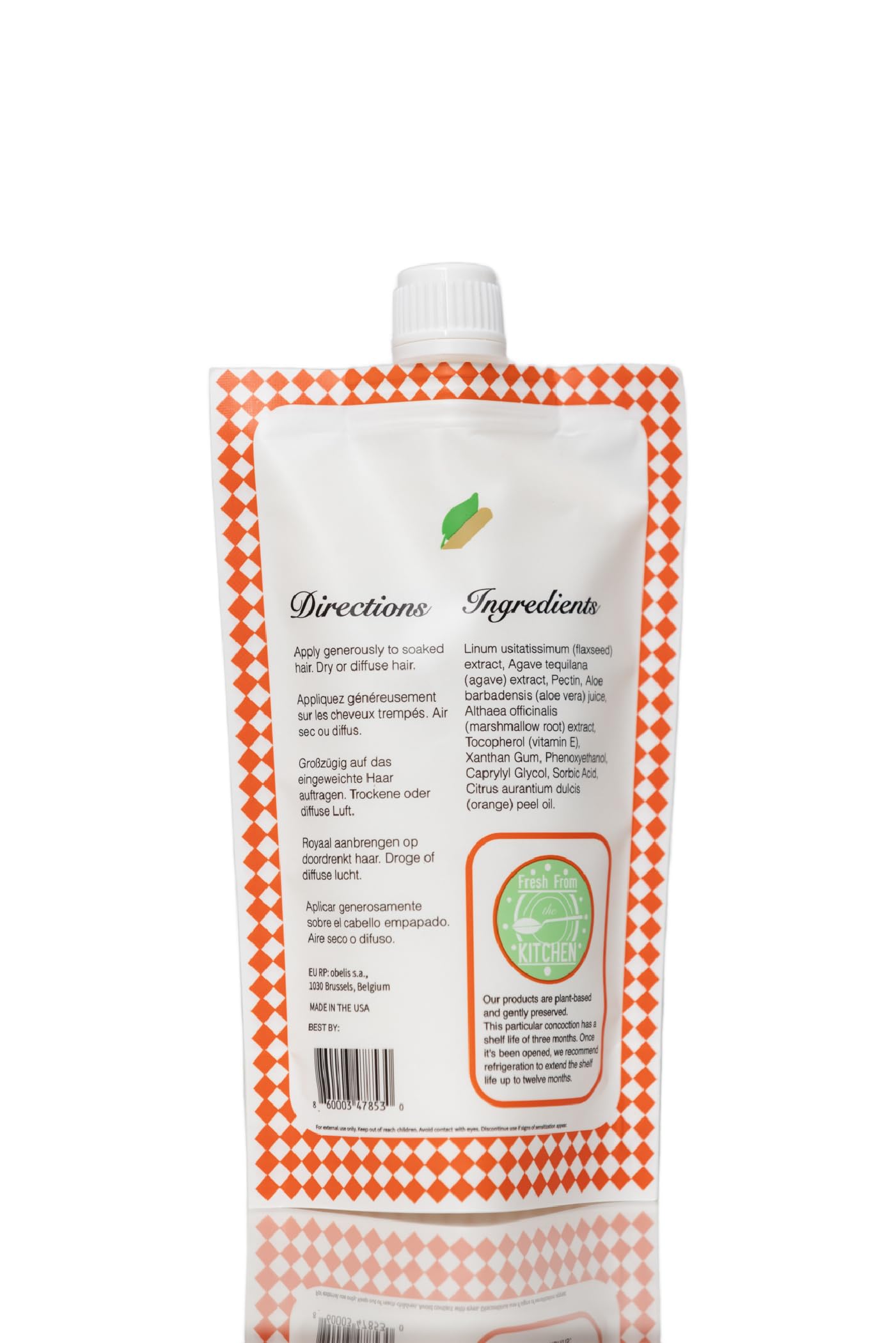 Ecoslay Orange Marmalade shine curls under light shows lustrous, hydrated curls.