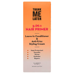 Hands applying Elizabeth Mott Thank Me Later primer to damp hair for smoother styling.