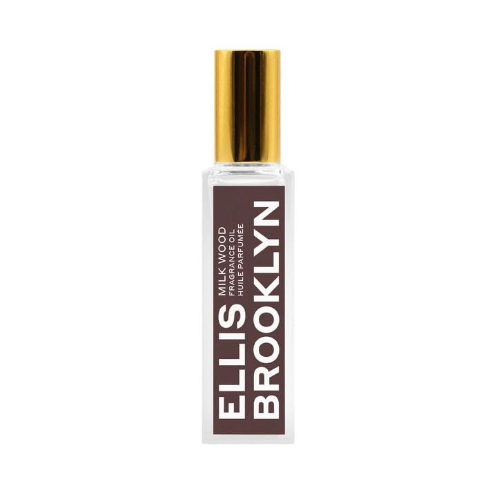 Ellis Brooklyn Milk Wood perfume oil roll-on bottle closeup, highlighting creamy fragrance notes
