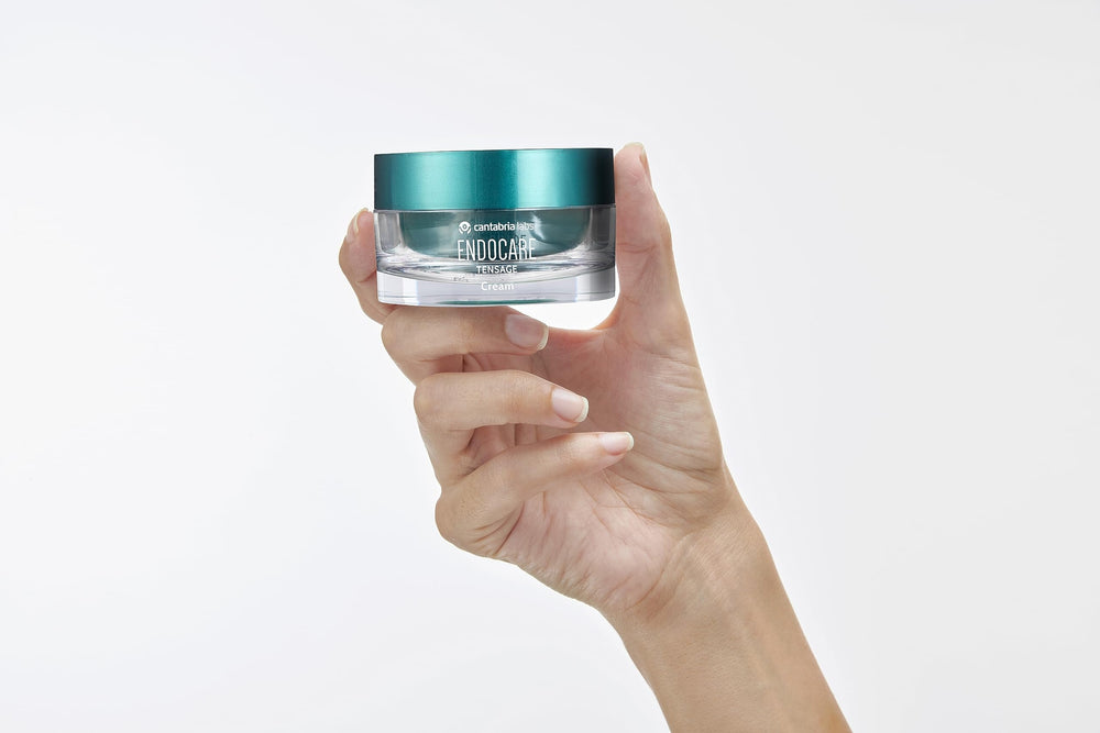 Shelf display of Endocare Tensage Cream suggests daily use for brighter skin.