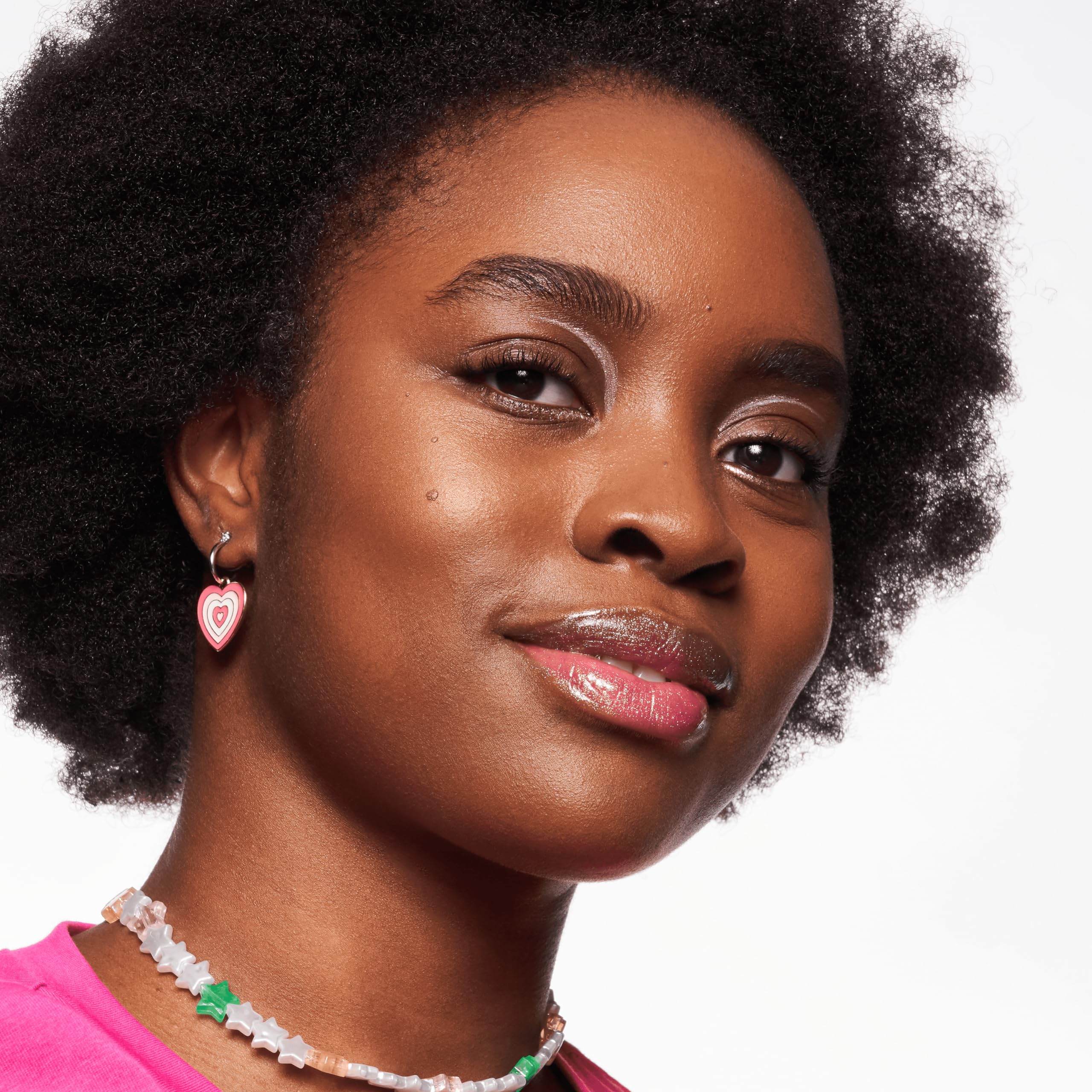 essence Meta Glow layered over lipstick adds dimensional color.