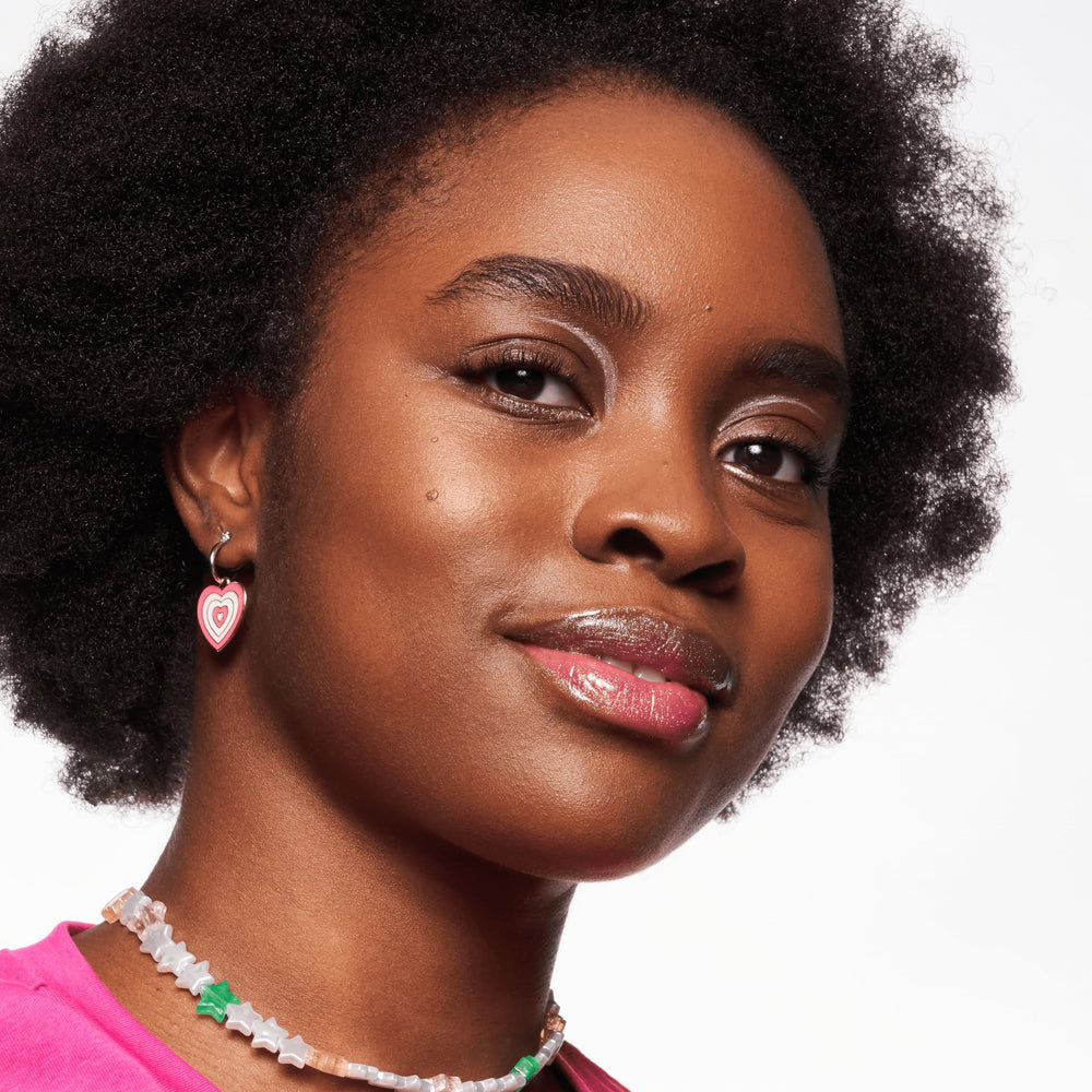 essence Meta Glow layered over lipstick adds dimensional color.