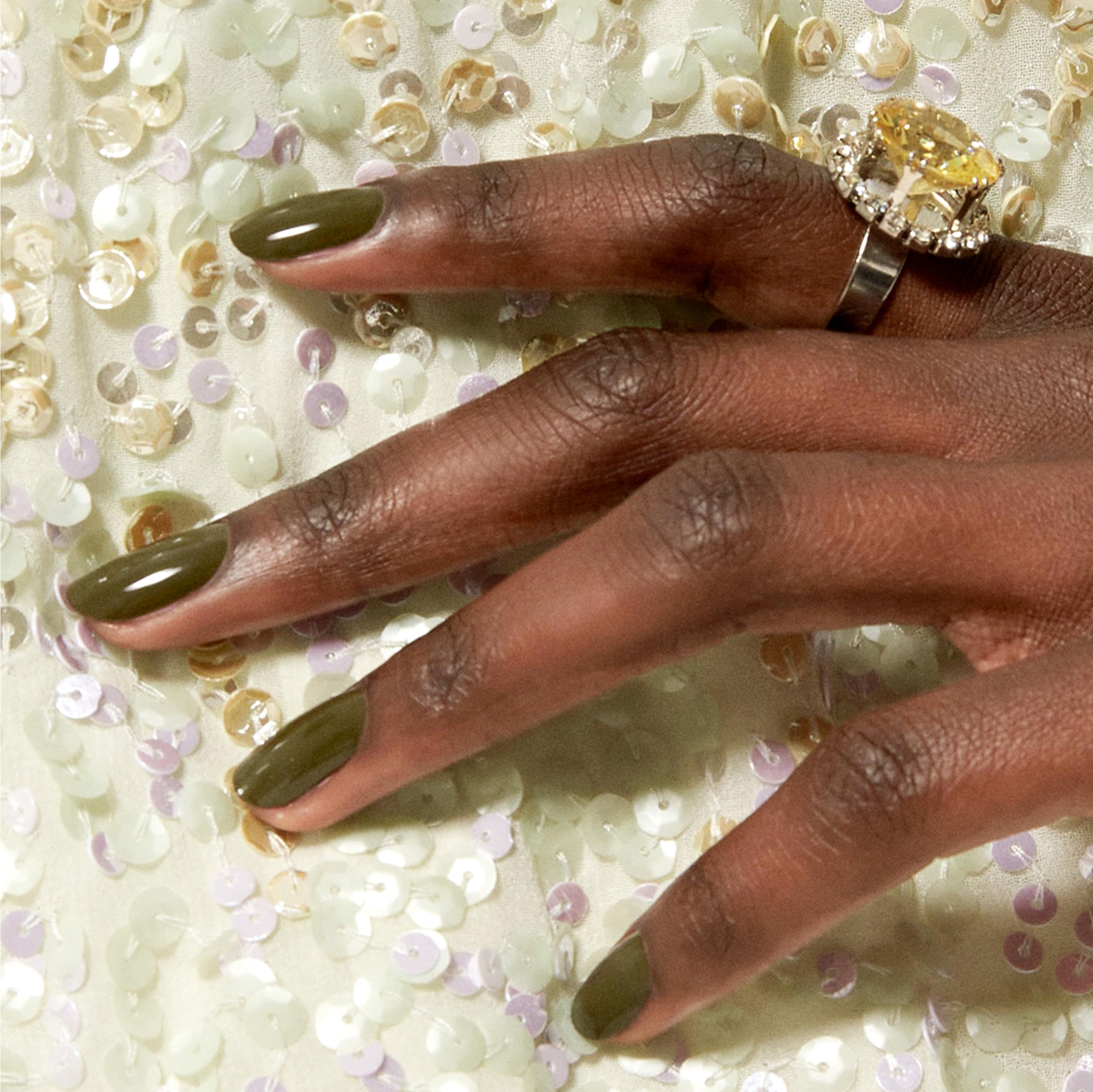 essie Meet Me at Midnight cream finish closeup highlights a smooth opaque olive green look