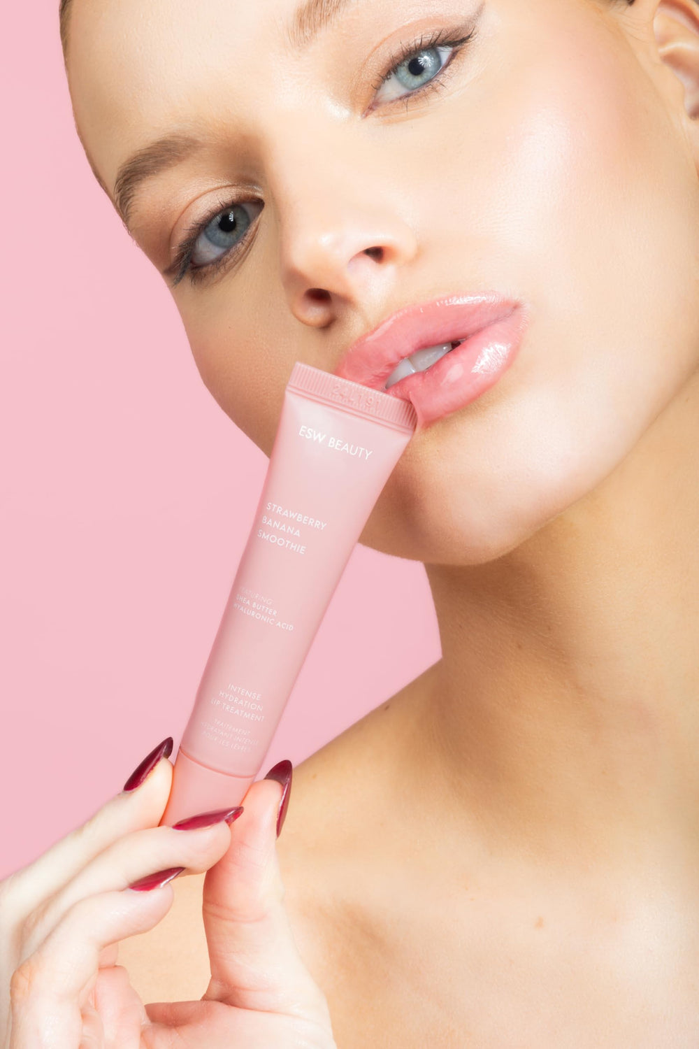 ESW Beauty Strawberry Banana Smoothie Lip Treatment premium gloss-like finish on lips.