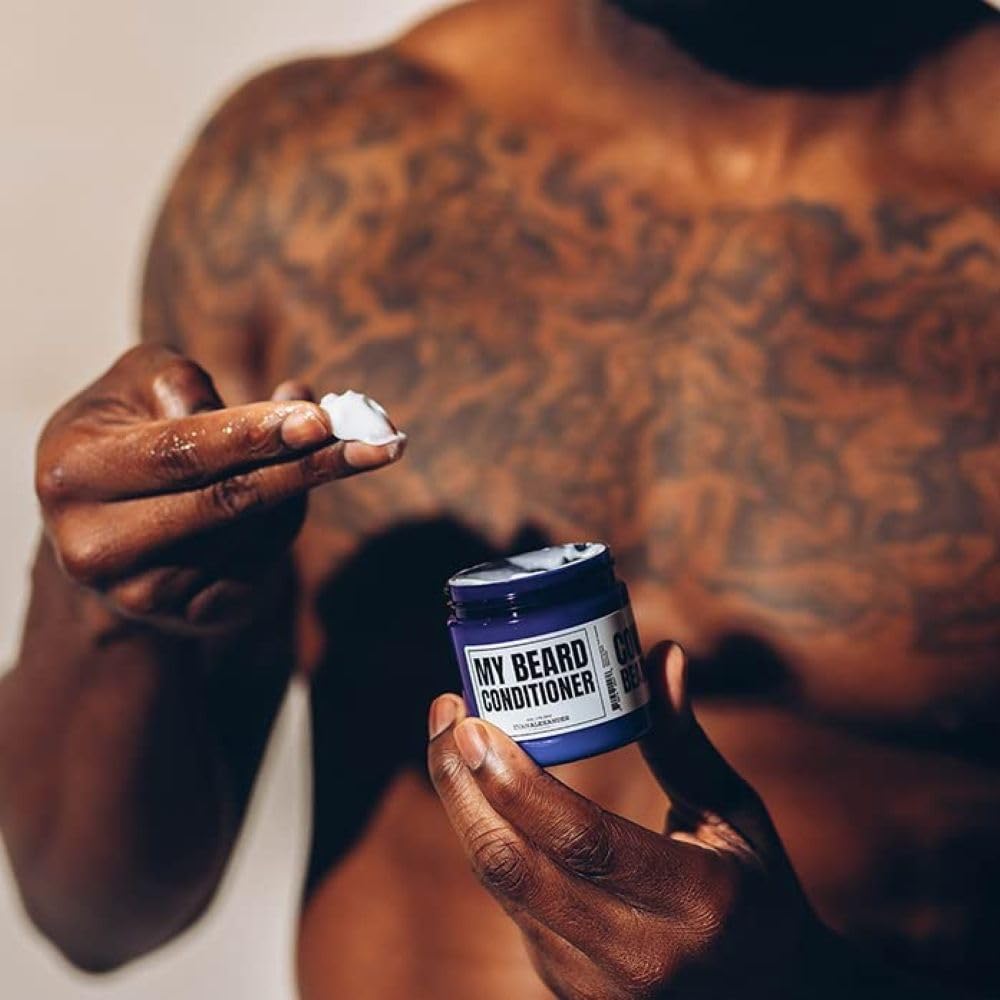 Hands apply Evan Alexander Grooming conditioner for smoother beard texture