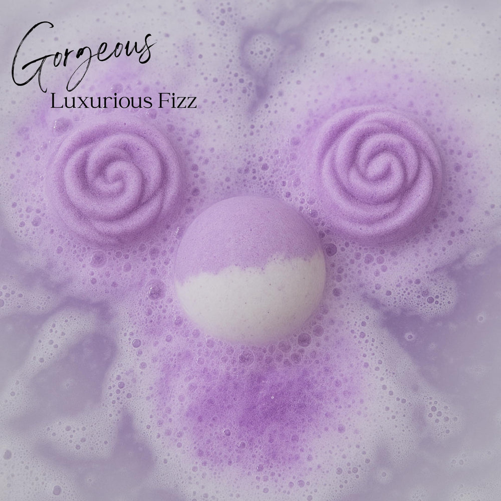 EvolutionUSA Lavender Dreams bath bombs releasing color and sparkle in water.