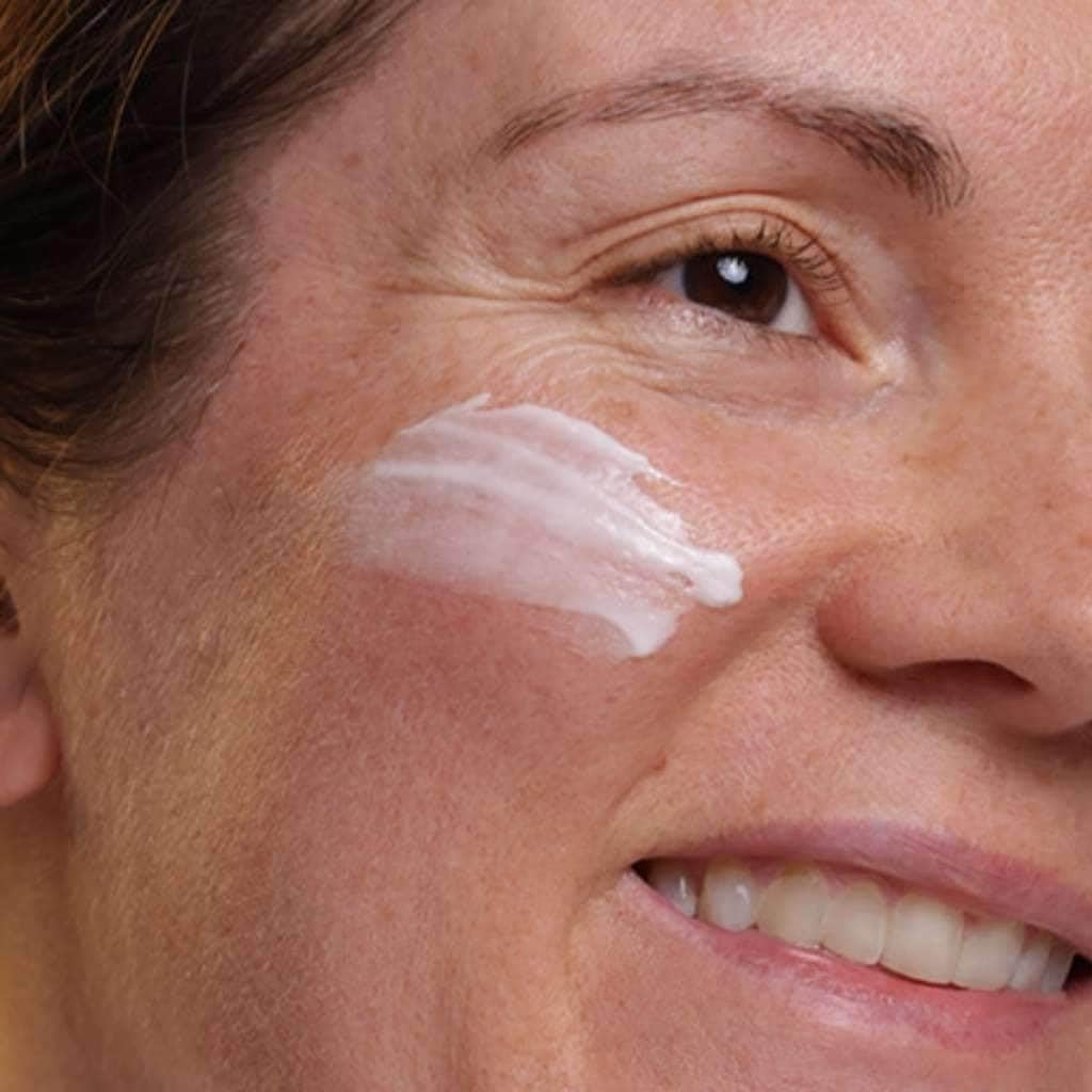 Evolve Nightly Renew hand applying cream with gentle massage motion