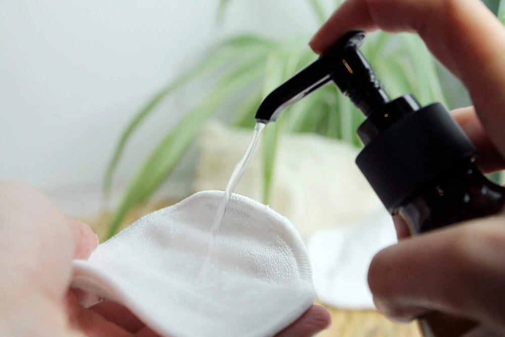 Makeup removal on a cotton pad demonstrates no-rinse cleansing with ease.