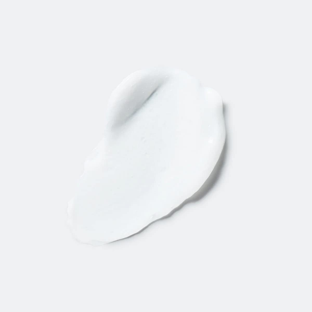 Pouring EVOLVh UltraShine Moisture Conditioner showing easy detangling application