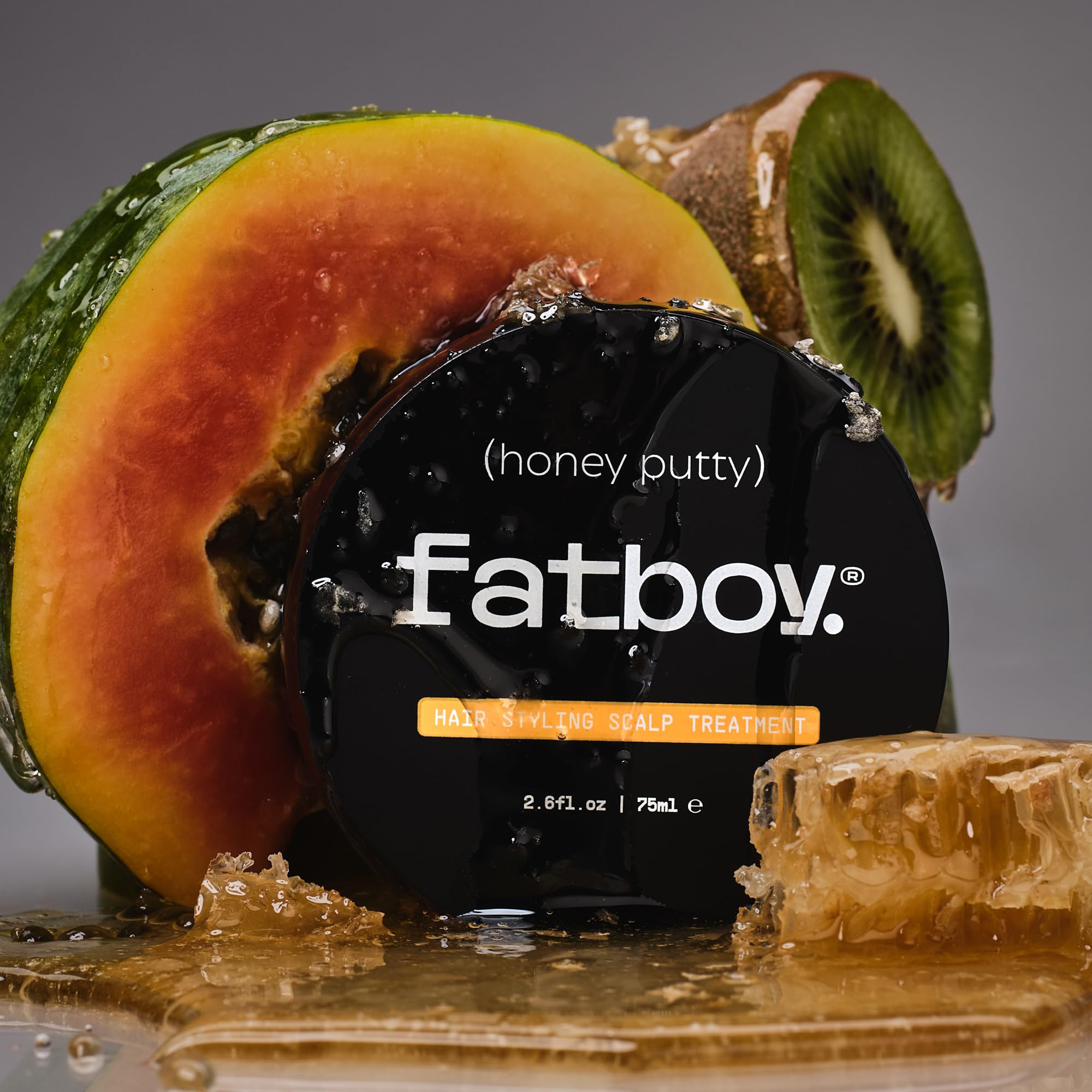 Fatboy Honey Putty smoothing hair with light hold and subtle shine.