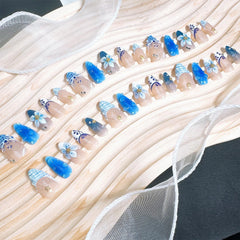 FDSQHSA shell pearl accents on blue flower nails add elegant detail.