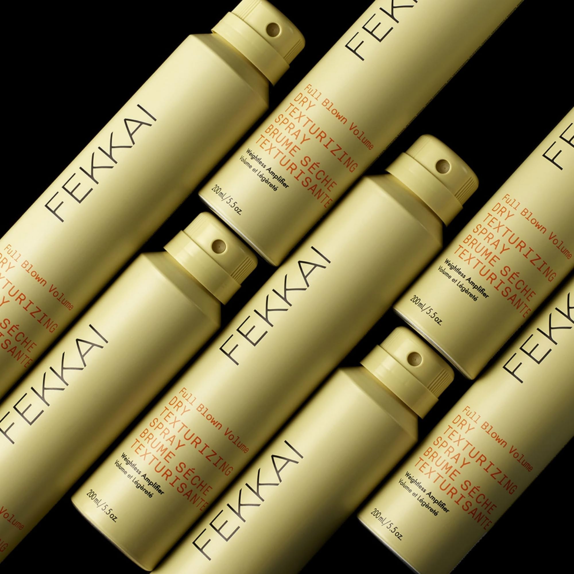FEKKAI Full Blown Volume Texturizer applying spray to hair for instant lift