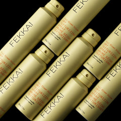 FEKKAI Full Blown Volume Texturizer applying spray to hair for instant lift
