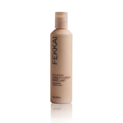 Fekkai Shea Butter Conditioner bottle demonstrates rich hydration for glossy, frizz-controlled hair